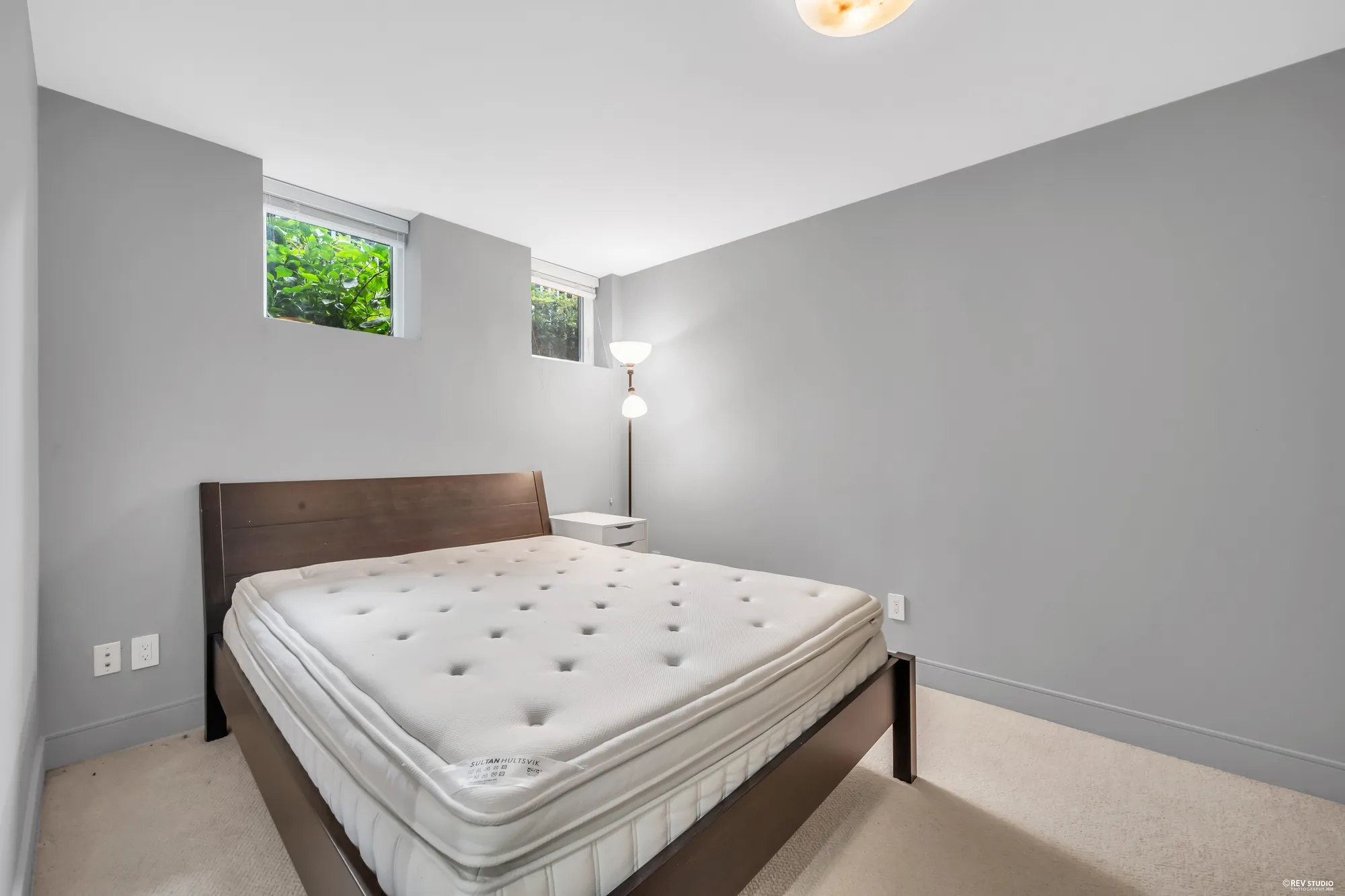 The second lower bedroom, a bed under a small window