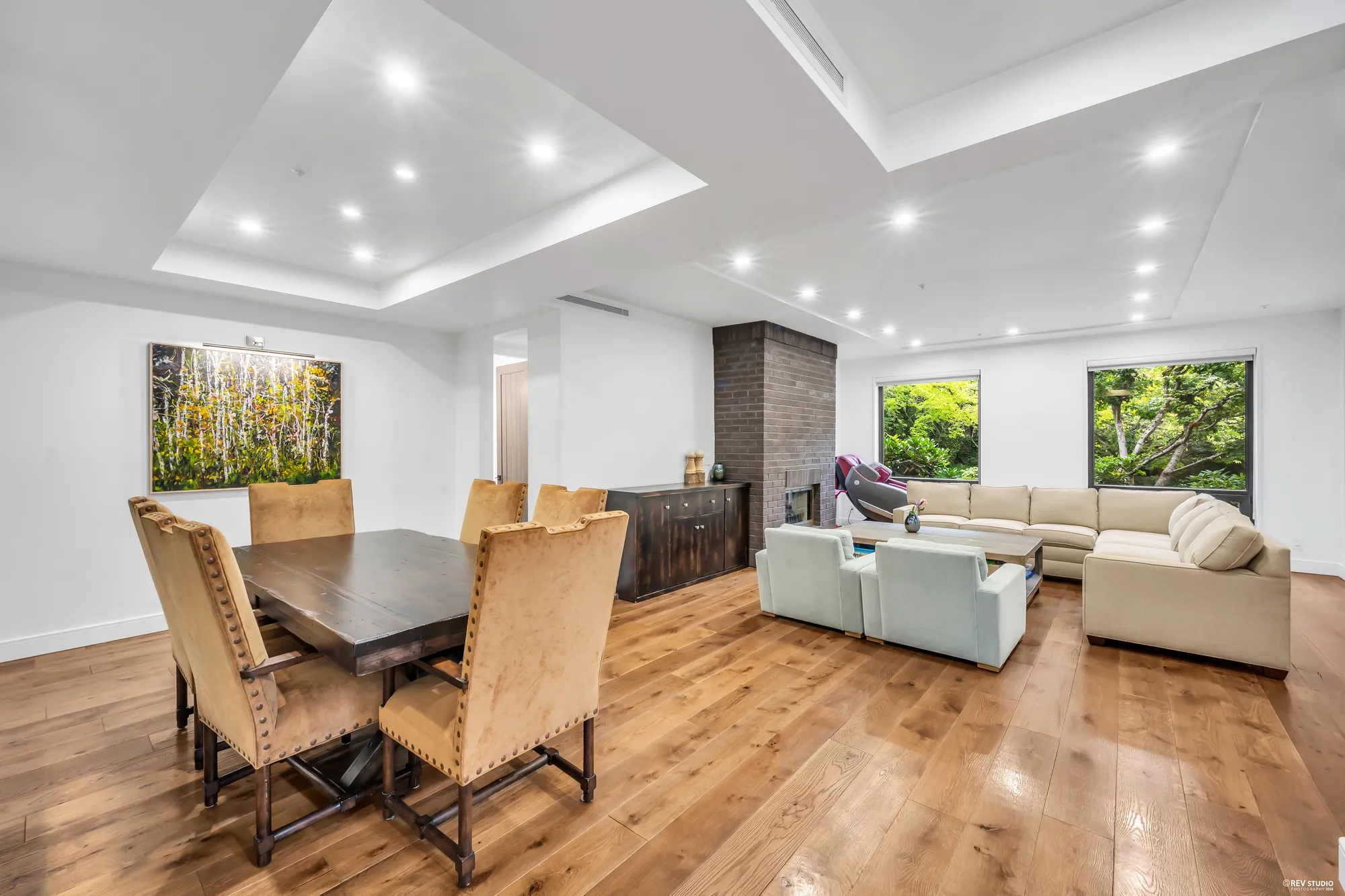 The dining table with the living room and the fireplace beyond