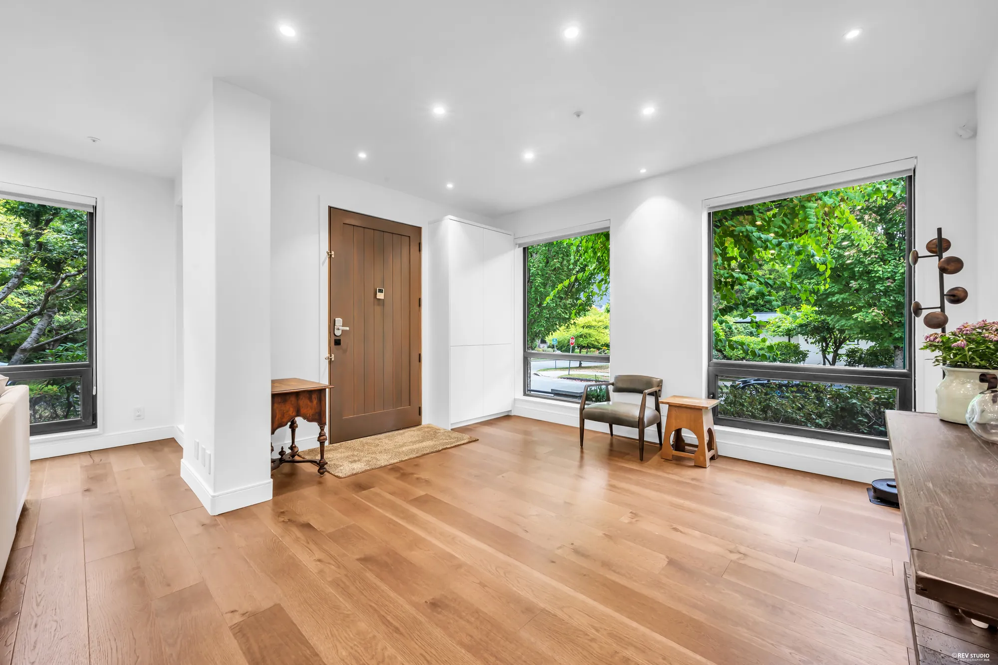 The foyer: the front door with windows either side, a small table and chairs